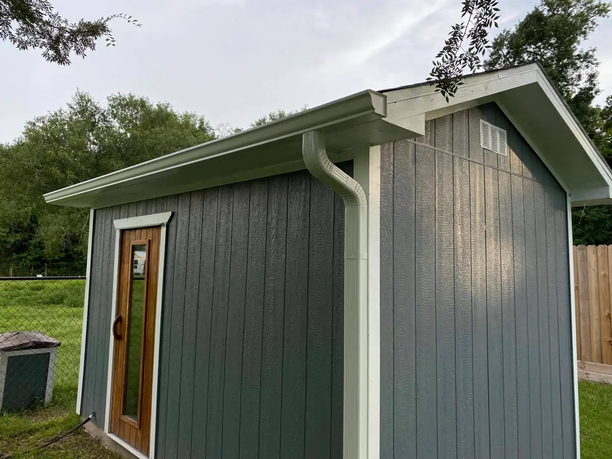 Finished white gutter and downspout installation